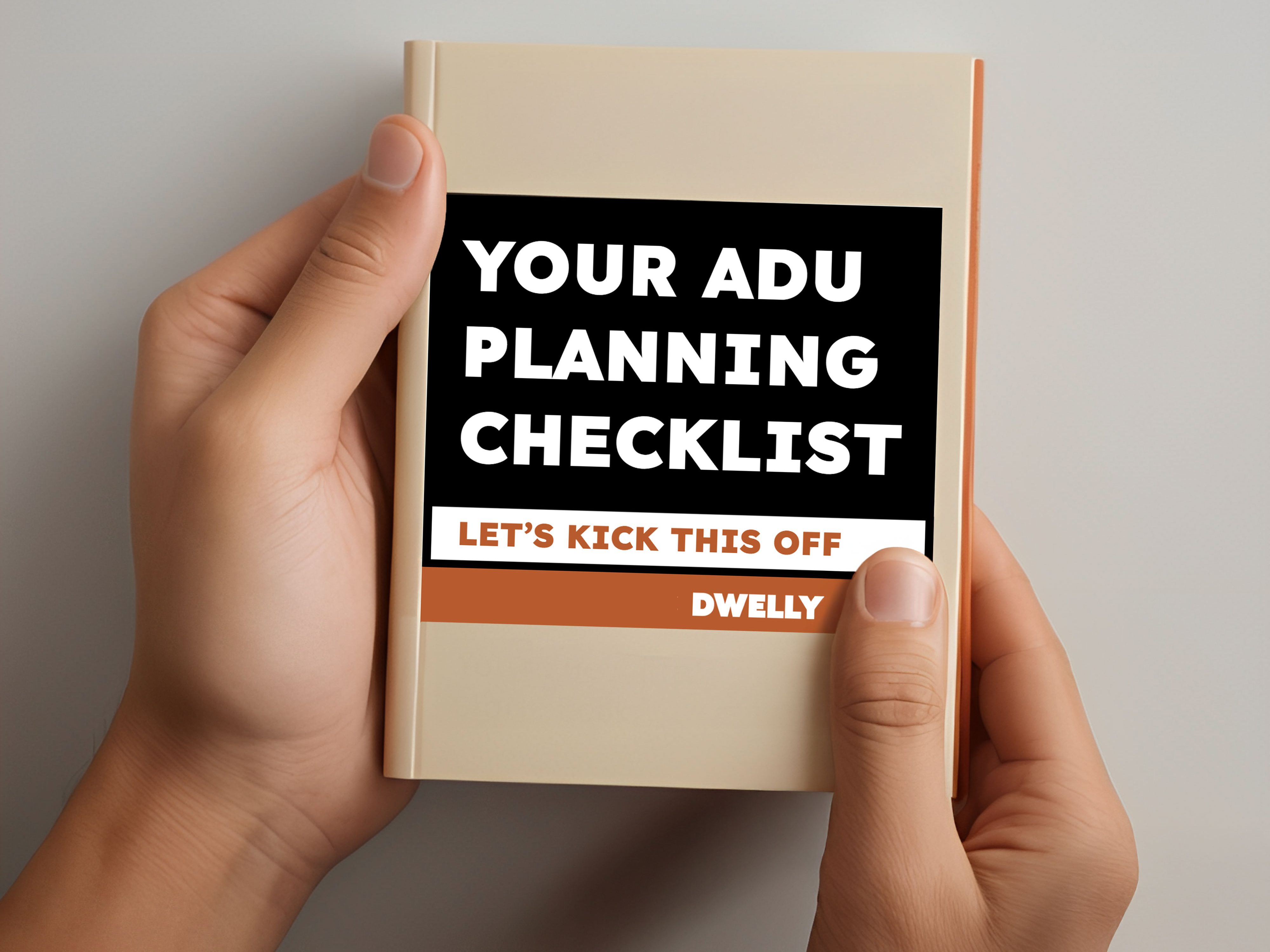 A person holding a checklist titled 'YOUR ADU PLANNING CHECKLIST' with the subtitle 'LET'S KICK THIS OFF' and the brand name 'DWELLY' at the bottom.