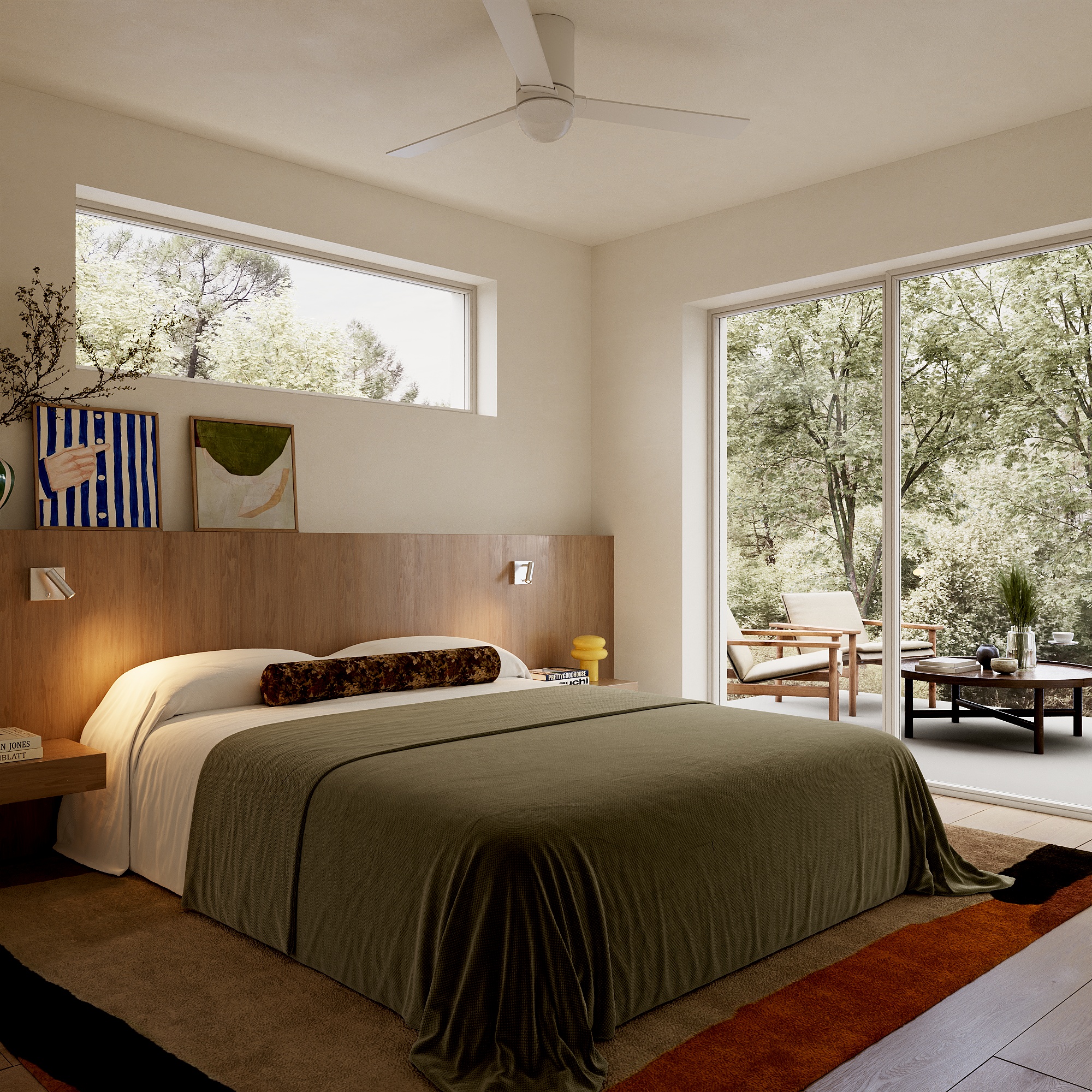 Modern bedroom with a large bed covered in an olive green throw, wooden headboard, and decorative pillows. There's a fan on the ceiling and artwork on the walls. A large window offers a view of an outdoor seating area with greenery outside.